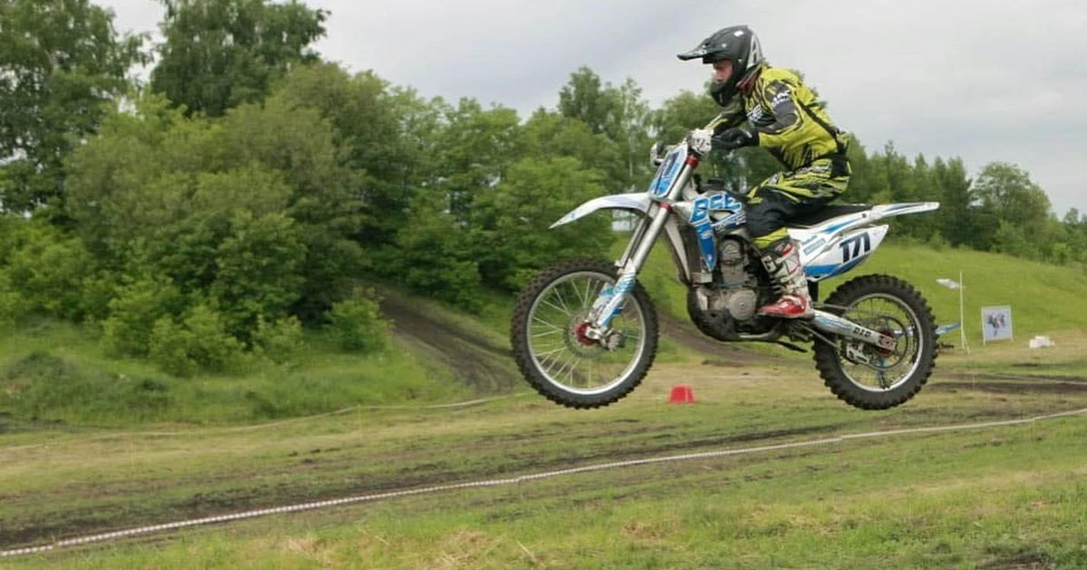 An off-road dirt bike racing through open field