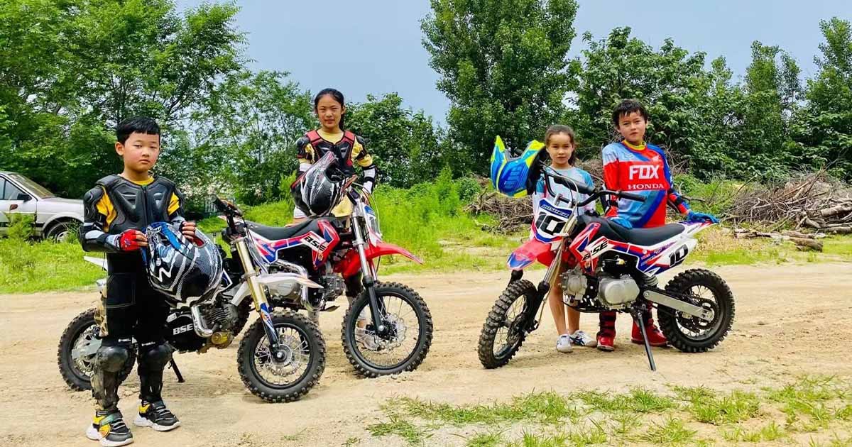 Young riders enjoying small dirt bikes