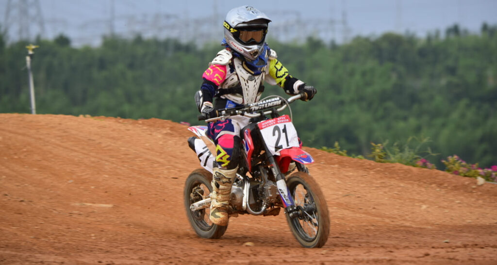Young beginer dirt bike rider riding 4 stroke dirt bike